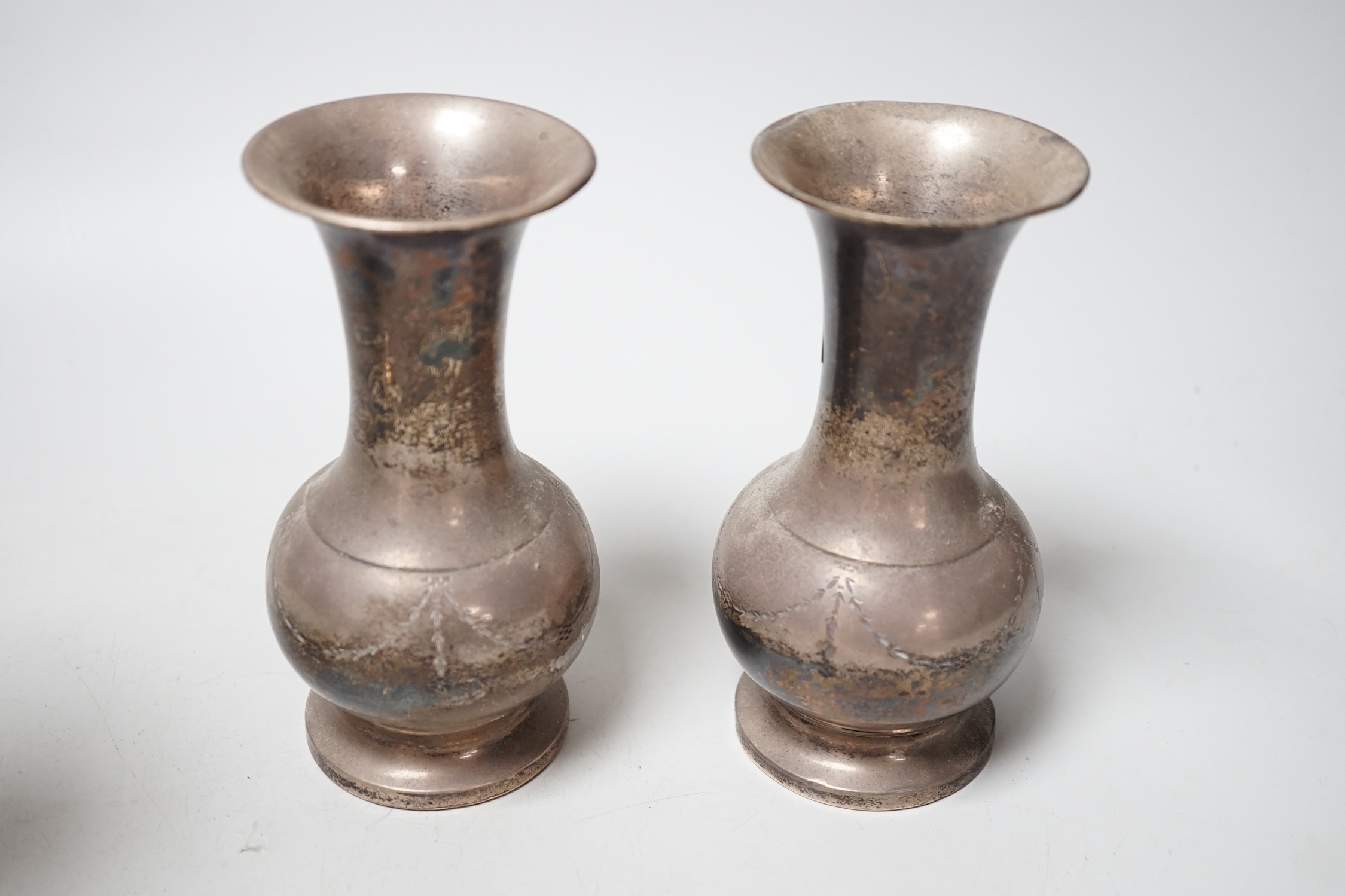 A pair of George V silver mounted spill vases, Birmingham, 1934, 14.2cm, weighted.